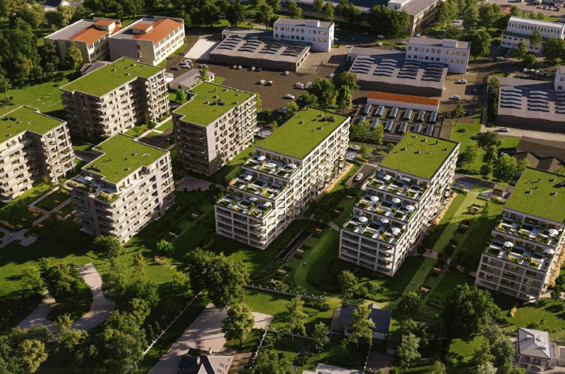 widok z lotu ptaka na układ 10 bloków wielorodzinnych z zielonymi dachami